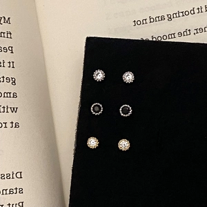 Detailed set of three sparkling round zircon stud earrings in gold and silver finishes