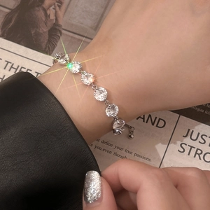 Elegant silver bracelet featuring eight round clear cubic zirconia stones and adjustable chain