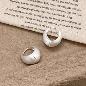 Elegant matte silver hoop earrings with brushed metal finish in a minimalist style