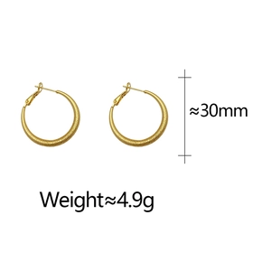 Detail of 30mm gold hoop earrings with glitter textured finish and 4.9g lightweight feel
