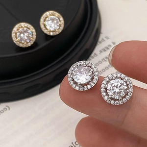 Pair of gold and silver halo cubic zirconia stud earrings with elegant round sparkling stones