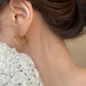 Minimalist gold square geometric hoop earrings with polished finish on model