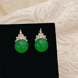 Close-up of green chalcedony crown stud earrings with sparkling cubic zirconia inlay