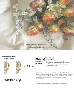 Detailed view of C-shaped pearl earrings with gold plating and cubic zirconia stones