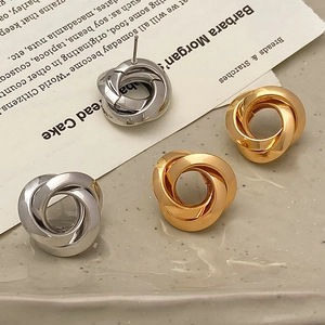 Classic gold and silver metal knot earrings set with sophisticated layered textures