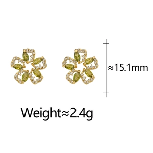 Detail of flower stud earrings with green marquise stones and white crystal accents