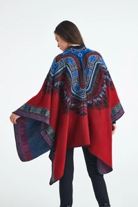 Detail view of red cashmere-feel knit shawl featuring ethnic blue and white patterns