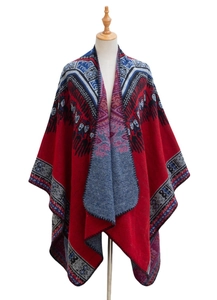 Detail of red jacquard cashmere shawl with blue ethnic geometric patterns and black edge stitching