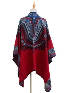 Macro detail of bohemian red pashmina shawl featuring navy geometric jacquard patterns