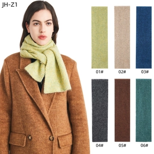 Detail view of winter knit scarves in six colors including lime green and dark blue