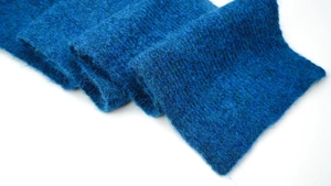 Close-up of soft royal blue wool knit scarf showing warm and fuzzy fiber texture
