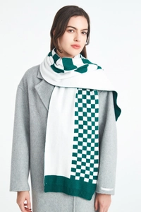 Detailed knit texture of green and white checkered scarf worn on a wool coat