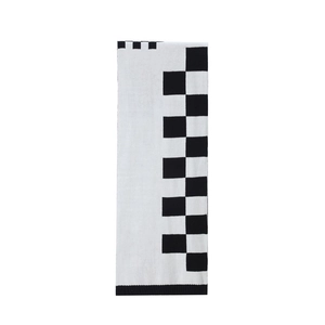 Detailed view of the black and white checkerboard knit scarf with classic contrast pattern