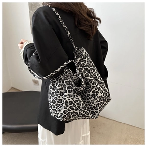 Detail of classic black and white leopard print tote bag with wide canvas shoulder straps