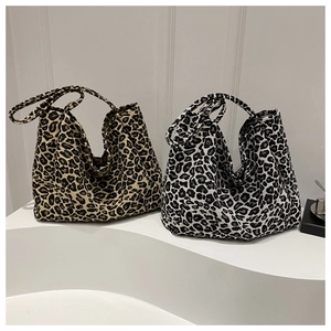 Large leopard print canvas tote bags in khaki and black-grey colors, shown side by side