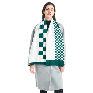 Green and white checkered knit scarf styled with a grey coat for winter wear