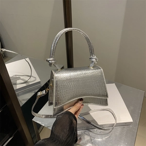 Silver crocodile-effect trapezoid handbag with a knot handle and curved base