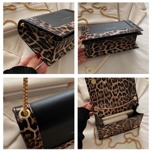 Detail showing leopard print pattern, gold chain strap, and interior of the small square bag