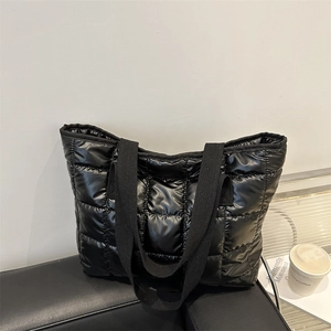 Minimalist black puffer quilted tote bag with square pattern and padded handles