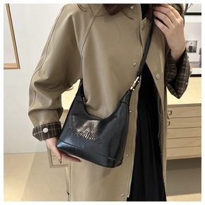 Minimalist black glossy leather shoulder bag for women with elegant embossed lettering