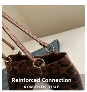 Detail of leopard print tote featuring silver metal rings and reinforced stitching