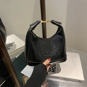 Modern black leather crescent hobo bag with embossed lettering and gold metal buckle
