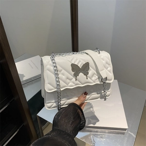 White quilted crossbody bag with silver butterfly metal ornament and chain strap