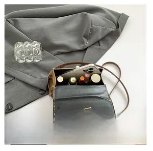 Interior capacity show of brown leather mini flap bag with smartphone and cosmetics