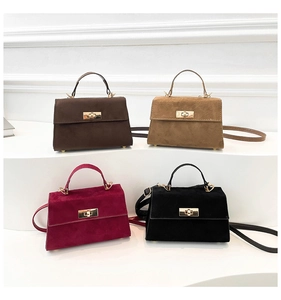 Detail of four matte suede small square bags in dark brown, khaki, wine red, and black