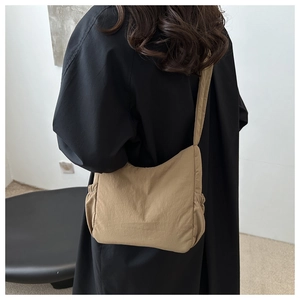 Detail of khaki drawstring tote bag with side pleats and ruched shoulder strap