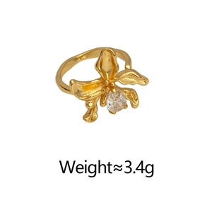 Macro shot of 3.4g gold-plated orchid ring with intricate metal texture and zircon core