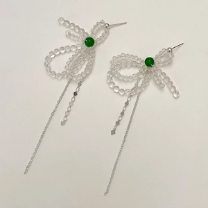 Transparent crystal bow tassel earrings with green center stone and silver chain drops