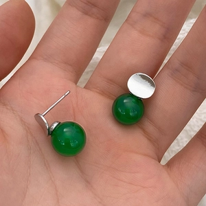 Vintage court style green chalcedony S925 silver stud earrings on a model's palm