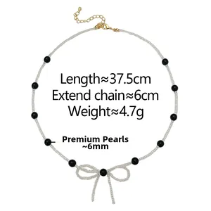 Detail of beaded necklace showing length 37.5cm and bow design with 6mm black pearls