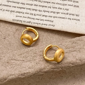Minimalist 18K gold plated hollow brushed hoop earrings on textured stone background