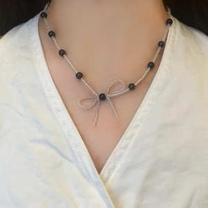 Elegant beaded pearl necklace with handcrafted transparent bow pendant for women