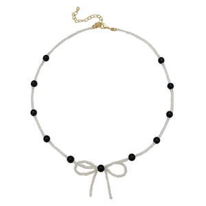 Elegant beaded pearl necklace featuring a handcrafted black and clear bow design centerpiece