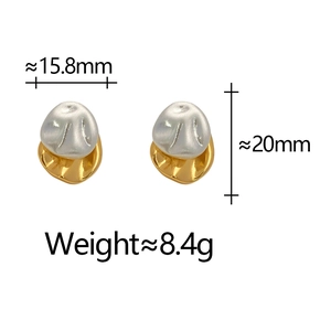 Detail view of irregular two-tone gold and silver studs with size measurements