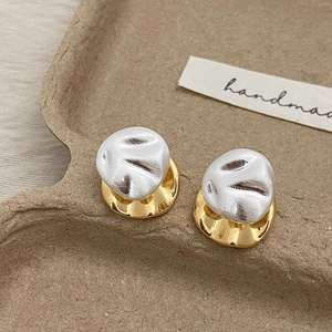 Elegant gold plated geometric earrings with white textured dome design and polished finish