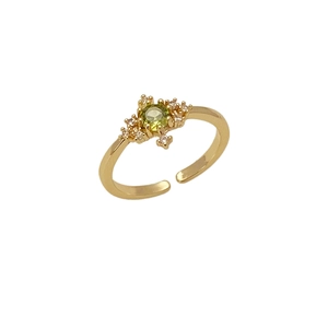 Close-up of emerald green zircon ring with gold plating and adjustable open band design