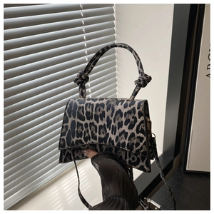 Détail du sac à main léopard avec poignée nouée unique et fermeture à rabat aimanté
