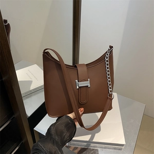 Vintage brown leather underarm bag with silver H-buckle and adjustable chain strap