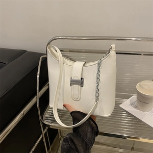 White faux leather shoulder bag with silver chain and metal buckle in trapezoid shape