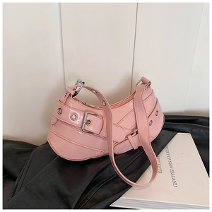 Close-up of pink Y2K style hobo bag featuring multiple decorative straps and silver eyelets