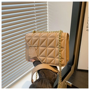 Close-up of beige quilted crossbody bag with gold square buckle and chain strap
