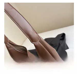 Detailed stitching on the brown leather strap and body of this casual tote bag