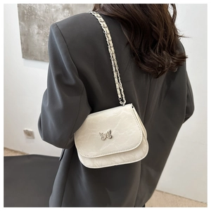 Chic white crossbody bag with silver butterfly buckle and leather chain strap detail