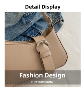Detail of khaki leather crescent bag with a polished silver buckle and neat stitching