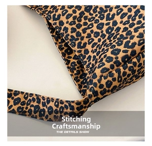 Detailed view of the leopard print canvas bag showing reinforced stitching and strap joint