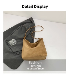 Detail view of khaki faux suede tote bag featuring slim leather shoulder straps and minimal design